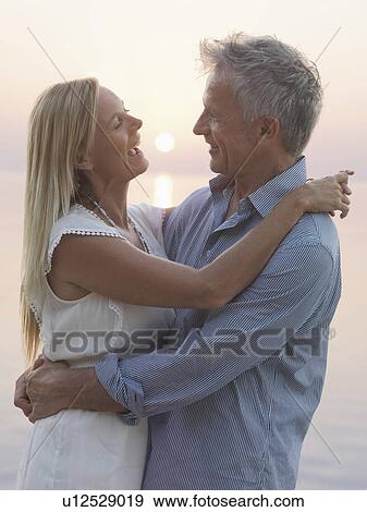 Stock Photo - Portrait of mature couple at sunset. Fotosearch