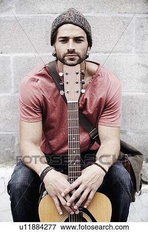 Portrait of musician against brick wall View Large Photo Image Stock Photo - Portrait of musician against brick wall. Fotosearch