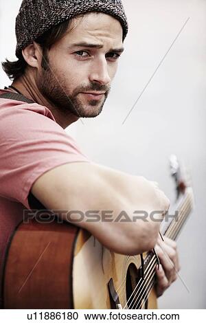 Portrait of musician playing guitar outdoors View Large Photo Image Stock Image - Portrait of musician playing guitar outdoors. Fotosearch
