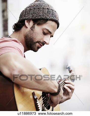 Portrait of musician playing guitar outdoors View Large Photo Image Stock Image - Portrait of musician playing guitar outdoors. Fotosearch