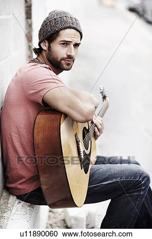 Portrait of musician playing guitar outdoors View Large Photo Image Stock Image - Portrait of musician playing guitar outdoors. Fotosearch