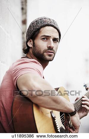 Portrait of musician playing guitar outdoors View Large Photo Image Stock Photograph - Portrait of musician playing guitar outdoors. Fotosearch
