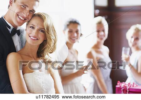 Portrait of newly wed couple, bridesmaids in background View Large Photo Image Stock Photography - Portrait of newly wed couple, bridesmaids in background. Fotosearch