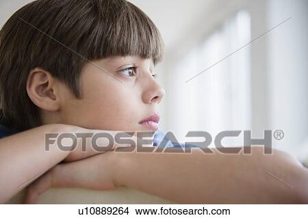 Picture - Portrait of pensive boy (8-9). Fotosearch
