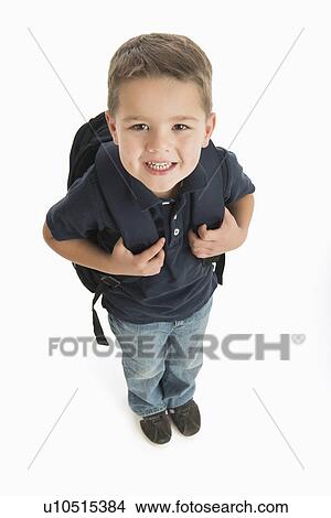 Portrait of schoolboy (4-5) carrying backpack View Large Photo Image Picture - Portrait of schoolboy (4-5) carrying backpack. Fotosearch
