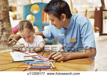Portrait of teacher and girl (3) at table View Large Photo Image Stock Photo - Portrait of teacher and girl (3) at table. Fotosearch