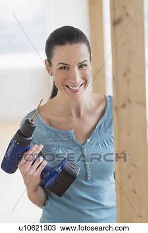 Portrait of woman using hand drill View Large Photo Image Stock Image - Portrait of woman using hand drill. Fotosearch
