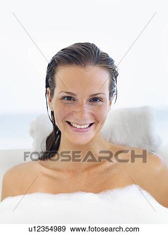 Stock Photo - Portrait of woman wrapped in soap sud. Fotosearch