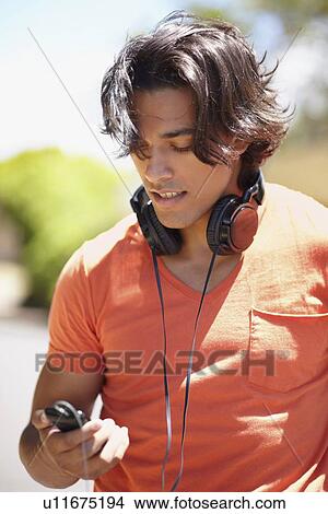 Portrait of young man with headphones View Large Photo Image Picture - Portrait of young man with headphones. Fotosearch