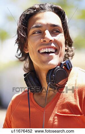 Portrait of young man with headphones View Large Photo Image Stock Image - Portrait of young man with headphones. Fotosearch
