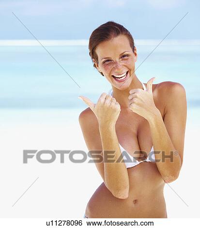 Portrait of young woman giving thumbs up View Large Photo Image Stock Photograph - Portrait of young woman giving thumbs up. Fotosearch