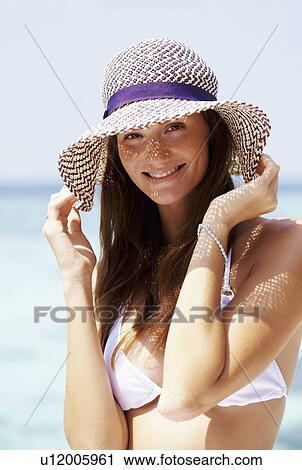 Portrait of young woman in bikini and straw hat View Large Photo Image Stock Image - Portrait of young woman in bikini and straw hat. Fotosearch
