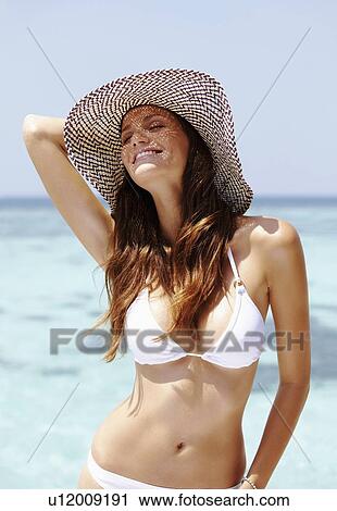 Portrait of young woman in bikini and straw hat View Large Photo Image Stock Image - Portrait of young woman in bikini and straw hat. Fotosearch