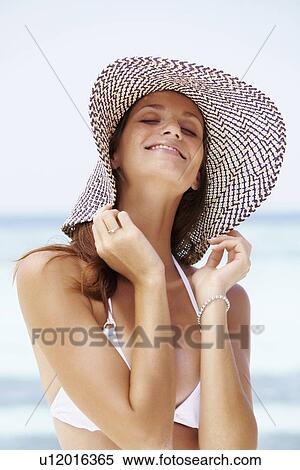 Portrait of young woman in bikini and straw hat View Large Photo Image Stock Photography - Portrait of young woman in bikini and straw hat. Fotosearch