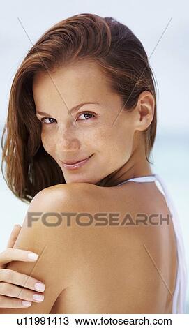 Stock Image - Portrait of young woman in bikini. Fotosearch