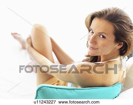 Portrait of young woman in bikini looking over shoulder View Large Photo Image Stock Photo - Portrait of young woman in bikini looking over shoulder. Fotosearch