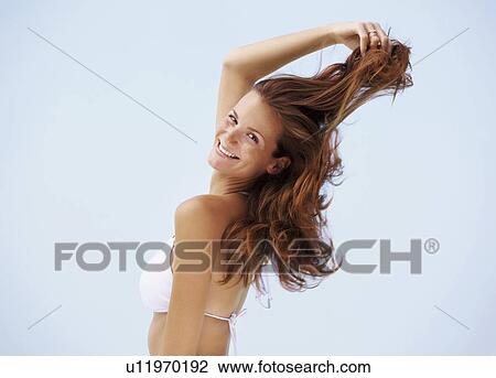 Portrait of young woman in bikini with hand in hair View Large Photo Image Stock Image - Portrait of young woman in bikini with hand in hair. Fotosearch