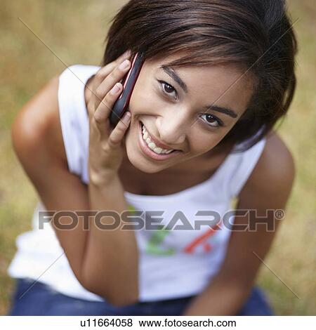 Portrait of young woman in using mobile phone View Large Photo Image Stock Photo - Portrait of young woman in using mobile phone. Fotosearch
