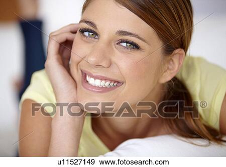 Portrait of young woman lying on bed View Large Photo Image Stock Photo - Portrait of young woman lying on bed. Fotosearch