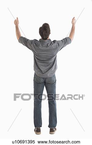 Stock Photography - Rear view of man raising arms. Fotosearch