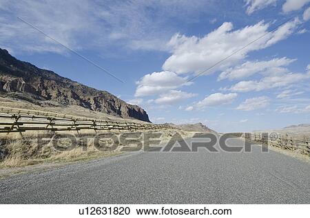 Road going through arid landscape View Large Photo Image Stock Image - Road going through arid landscape. Fotosearch
