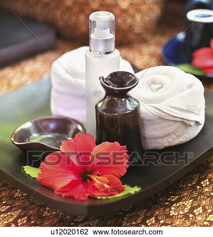 Stock Image - Rolled up towels on tray in spa. Fotosearch