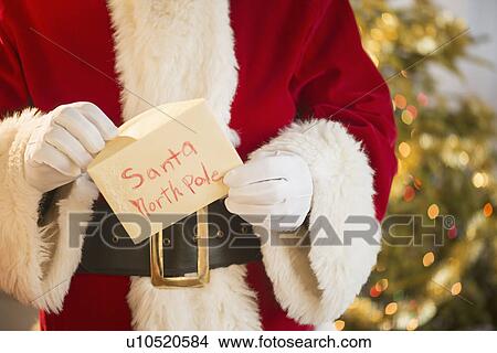 Santa claus holding letter View Large Photo Image Picture - Santa claus holding letter. Fotosearch