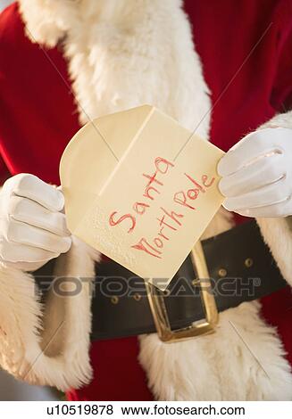 Santa claus holding letter View Large Photo Image Stock Photo - Santa claus holding letter. Fotosearch