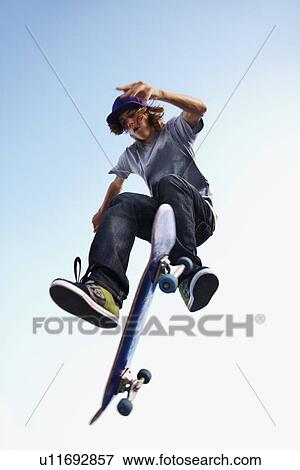 Skater performing jump View Large Photo Image Stock Photo - Skater performing jump. Fotosearch