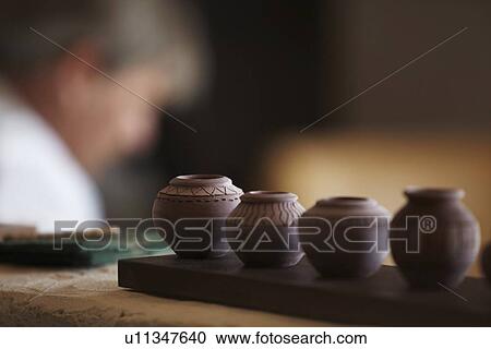 Small vases in row, man in background View Large Photo Image Stock Image - Small vases in row, man in background. Fotosearch