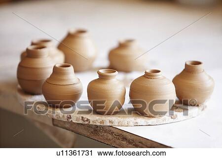 Stock Image - Small vases left to dry. Fotosearch