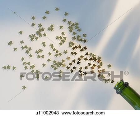 Stock Photo - Star shape confetti splashing out of champagne bottle. Fotosearch