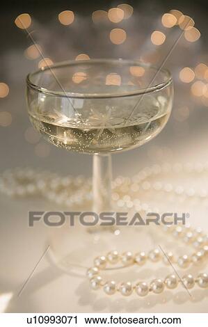 Stock Image - Still life with champagne and pearls. Fotosearch