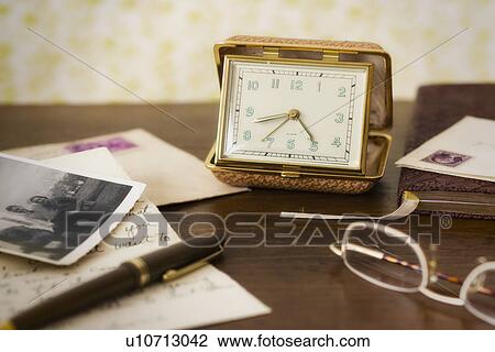 Still life with clock, spectacles and old photos View Large Photo Image Stock Image - Still life with clock, spectacles and old photos . Fotosearch