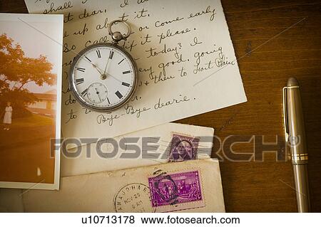 Stock Photo - Still life with pocket watch, old letter and photograph. Fotosearch