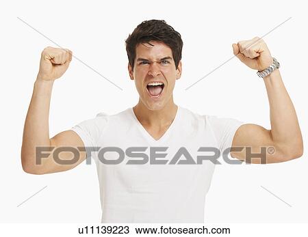 Studio portrait of handsome man cheering and flexing muscles View Large Photo Image Stock Image - Studio portrait of handsome man cheering and flexing muscles. Fotosearch