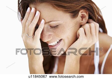 Stock Photo - Studio portrait of laughing woman. Fotosearch