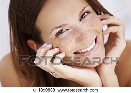 Stock Photo - Studio portrait of woman smiling. Fotosearch