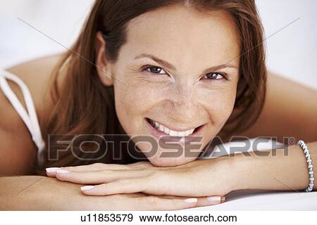 Studio portrait of woman smiling View Large Photo Image Stock Photo - Studio portrait of woman smiling. Fotosearch