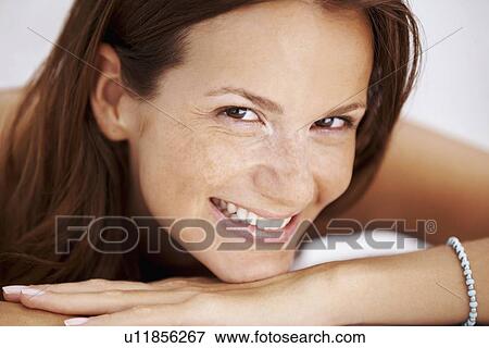 Studio portrait of woman smiling View Large Photo Image Stock Photo - Studio portrait of woman smiling. Fotosearch