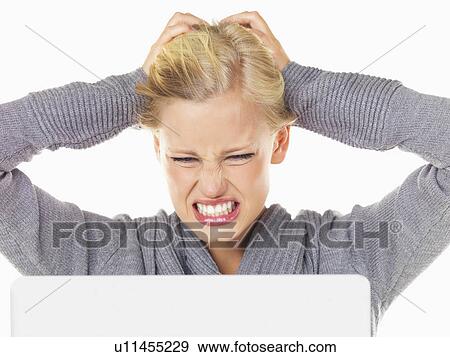 Studio portrait of young woman being frustrated in front of computer View Large Photo Image Stock Photo - Studio portrait of young woman being frustrated in front of computer. Fotosearch