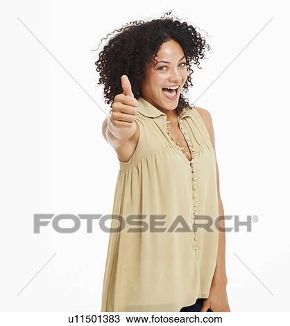 Stock Image - Studio portrait of young woman gesturing. Fotosearch