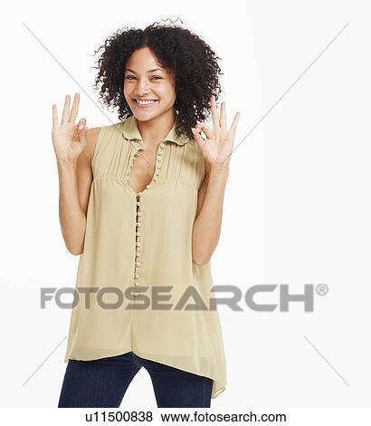 Stock Photo - Studio portrait of young woman gesturing. Fotosearch