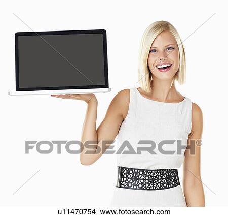 Studio portrait of young woman holding laptop View Large Photo Image Picture - Studio portrait of young woman holding laptop. Fotosearch