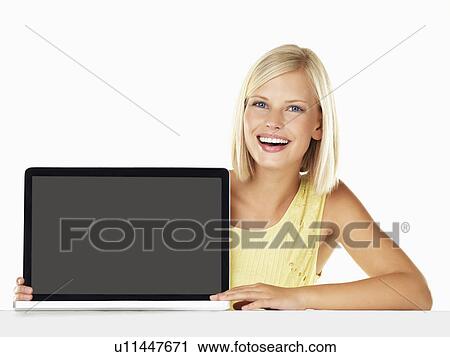 Studio portrait of young woman holding new laptop View Large Photo Image Stock Image - Studio portrait of young woman holding new laptop. Fotosearch