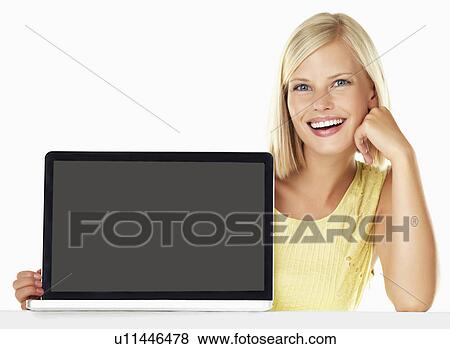 Studio portrait of young woman holding new laptop View Large Photo Image Stock Photo - Studio portrait of young woman holding new laptop. Fotosearch