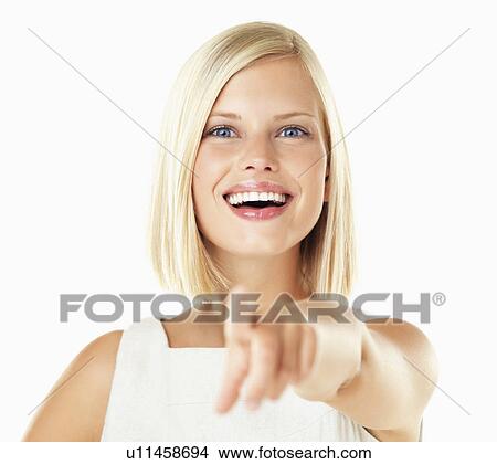 Studio portrait of young woman pointing View Large Photo Image Picture - Studio portrait of young woman pointing. Fotosearch