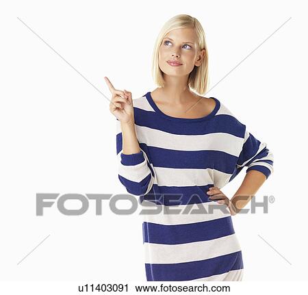 Studio portrait of young woman pointing View Large Photo Image Stock Image - Studio portrait of young woman pointing. Fotosearch