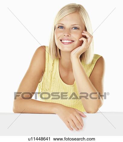Stock Image - Studio portrait of young woman. Fotosearch