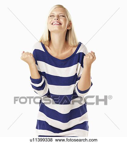 Studio portrait of young woman clenching fists View Large Photo Image Stock Photo - Studio portrait of young woman clenching fists. Fotosearch